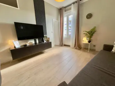a large living room with a flat screen tv at Cosy Home Cannes - Croisette in Cannes