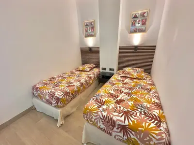 a room with two beds in a room at Cosy Home Cannes - Croisette in Cannes