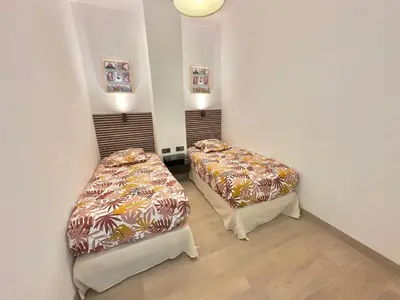 a room with two beds in a room at Cosy Home Cannes - Croisette in Cannes