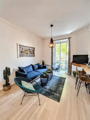 a living room with a blue couch and chairs at FRGK 
