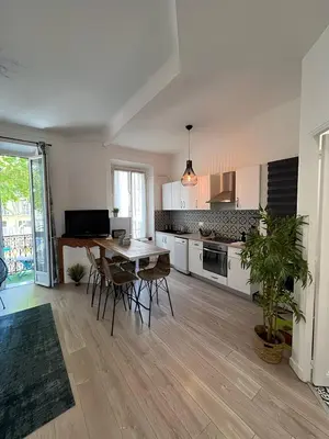 a living room with a blue couch and a table at FRGK 