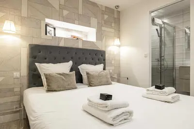 a bedroom with a white bed with towels on it at Beautiful apartment, next to Croisette Gray Albion in Cannes