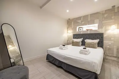 a bedroom with a large bed and a mirror at Beautiful apartment, next to Croisette Gray Albion in Cannes