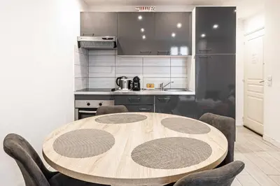 a kitchen with a wooden table and some chairs at Beautiful apartment, next to Croisette Gray Albion in Cannes
