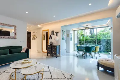 a living room with a green couch and a table at RARE! 2-Br with Pools Beach Access Private Parking in Cannes