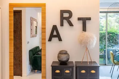 a living room with a sign that reads rent at RARE! 2-Br with Pools Beach Access Private Parking in Cannes