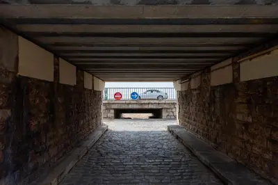 a brick tunnel with a car in the background at RARE! 2-Br with Pools Beach Access Private Parking in Cannes