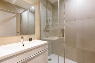 a bathroom with a sink and a shower at L'Elégant YourHostHelper in Cannes