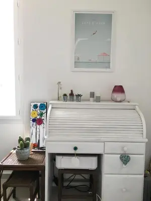 a white dresser in a room with a picture on the wall at Cannes congrès in Cannes