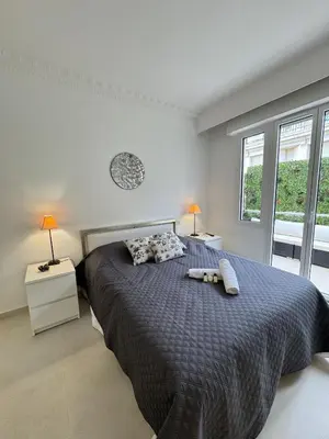 a bedroom with a bed with two stuffed animals on it at Apt moderne et luxueux a Cannes Res Miramar in Cannes