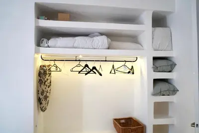 a room with white shelves with towels on them at T2 Appartement 55m2 Terrasse 20m2 - à 15min à pied du Centre Ville - Wifi - Air conditioning in Cannes
