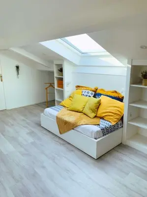 a bedroom with a bed with yellow pillows on it at CANNES CENTRE proche PLAGE CROISETTE PALAIS DES FESTIVALS in Cannes