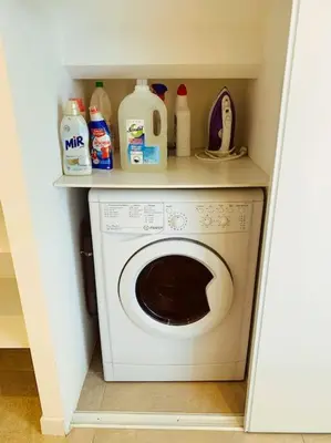 a laundry room with a washing machine in a closet at CANNES CENTRE proche PLAGE CROISETTE PALAIS DES FESTIVALS in Cannes