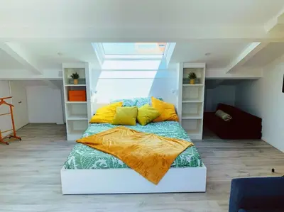 a bedroom with a bed with yellow pillows at CANNES CENTRE proche PLAGE CROISETTE PALAIS DES FESTIVALS in Cannes