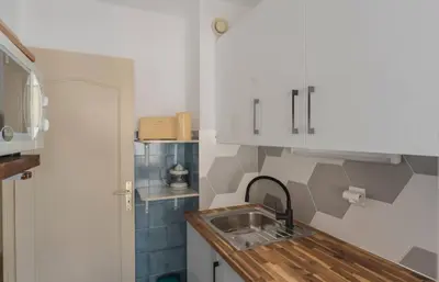 a kitchen with a sink and a counter top at Studio Fenelon terrasse et Parking Cannes in Cannes