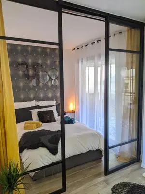 a bedroom with a bed and a large mirror at Centre Cannes 2-Bed Apt & garage 5min Croisette in Cannes