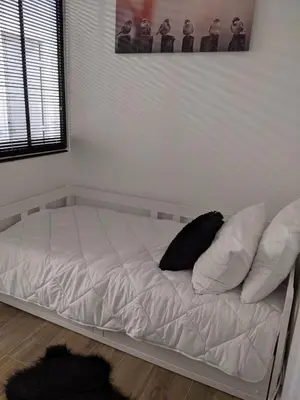 a bed with white sheets and pillows in a room at Centre Cannes 2-Bed Apt & garage 5min Croisette in Cannes