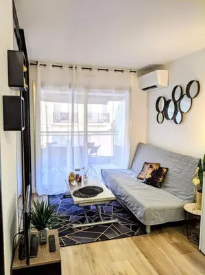 a living room with a couch and a window at Centre Cannes 2-Bed Apt & garage 5min Croisette in Cannes