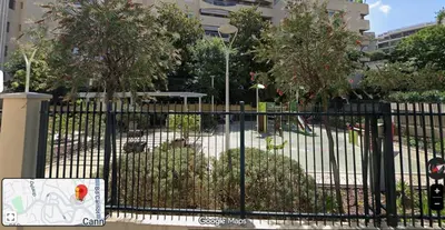 a black fence with trees in a park at Centre Cannes 2-Bed Apt & garage 5min Croisette in Cannes
