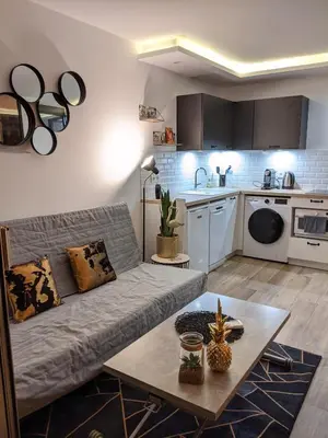 a living room with a couch and a table at Centre Cannes 2-Bed Apt & garage 5min Croisette in Cannes