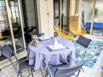 a table with chairs and a purple table cloth on it at Centre Cannes 2-Bed Apt & garage 5min Croisette in Cannes