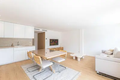 a kitchen and living room with a table and a couch at Sublime 3 pièces entièrement rénové dans le centre de Cannes in Cannes