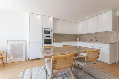 a kitchen with a table and chairs in a room at Sublime 3 pièces entièrement rénové dans le centre de Cannes in Cannes
