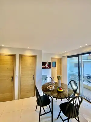 a dining room with a table and chairs at Appartement proche mer SC MACH in Cannes
