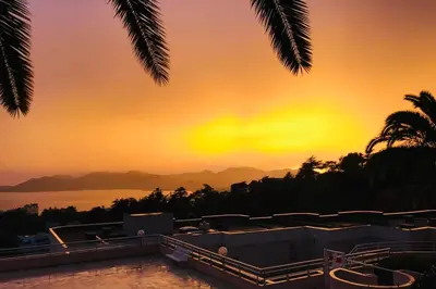 a view of the sunset from a house with a swimming pool at Le Seaview - Calm - Pool - Farniente - Sea view in Cannes