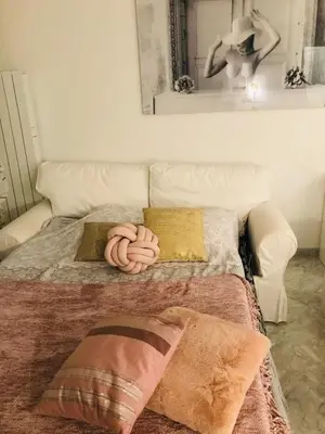a bed with pillows on it in a room at Le Seaview - Calm - Pool - Farniente - Sea view in Cannes