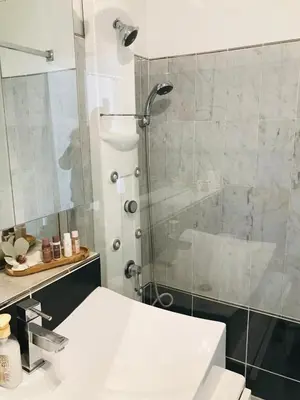 a bathroom with a shower and a white sink at Le Seaview - Calm - Pool - Farniente - Sea view in Cannes
