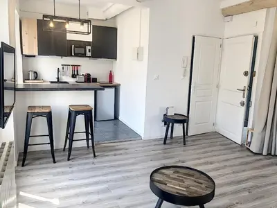 a kitchen with a counter and stools in a room at Carré d'Or F1bis Croisette 1 mn Olam Properties in Cannes