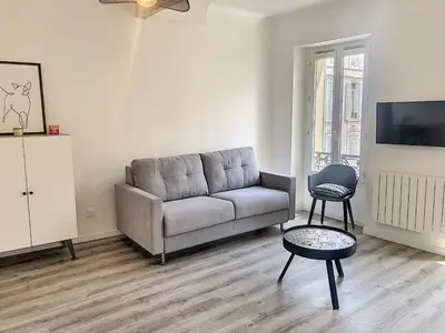 a living room with a couch and a table at Carré d'Or F1bis Croisette 1 mn Olam Properties in Cannes