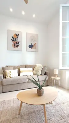 a living room with a couch and a table at Studio rénové, vue dégagée et arborée, 700m plage in Cannes