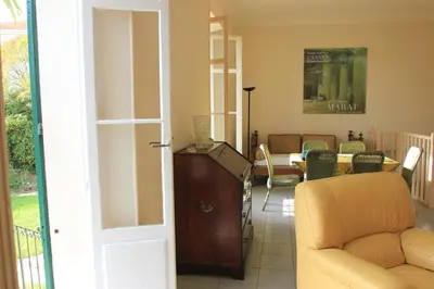 a living room with a couch and a table at Villa Cottage Reine, RC Jardin in Cannes