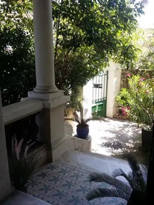 a porch with a pillar and plants on a patio at Villa Cottage Reine, RC Jardin in Cannes