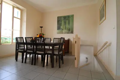 a dining room with a table and four chairs at Villa Cottage Reine, RC Jardin in Cannes