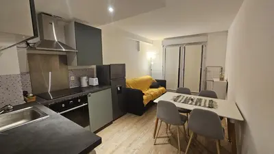 a kitchen with a table and chairs in a room at Studio à Cannes La Bocca in Cannes