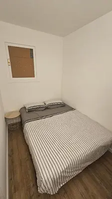 a bed in a room with a striped mattress at Studio à Cannes La Bocca in Cannes