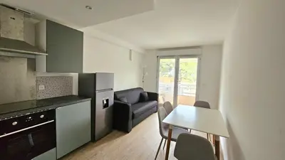 a kitchen and dining room with a table and chairs at Studio à Cannes La Bocca in Cannes