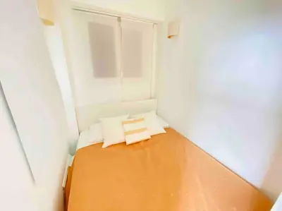 a small room with a bed and a window at Amazing sea view, parking, easy beach access in Cannes