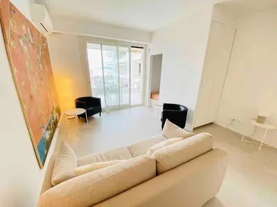 a white living room with a couch and chairs at Amazing sea view, parking, easy beach access in Cannes