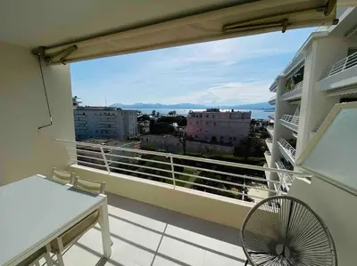 a balcony with a view of a city at Amazing sea view, parking, easy beach access in Cannes