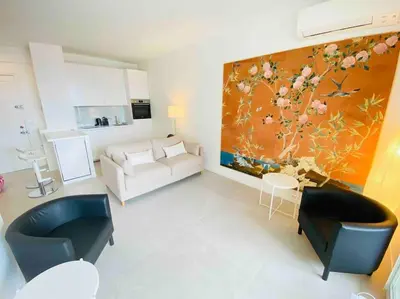 a living room with a large painting on the wall at Amazing sea view, parking, easy beach access in Cannes