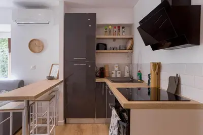 a kitchen with a black refrigerator and a counter at Hakuna Matata Cannes - clim, plages, Palais in Cannes
