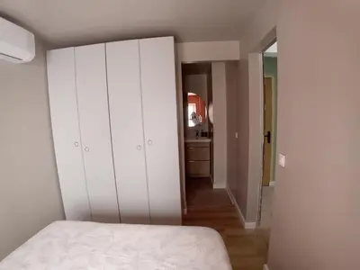 a bedroom with a white bed and a hallway at Hakuna Matata Cannes - clim, plages, Palais in Cannes