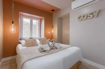 a bedroom with a bed with two stuffed animals on it at Hakuna Matata Cannes - clim, plages, Palais in Cannes