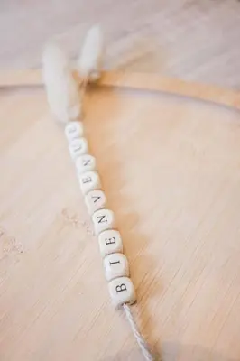 a wooden table with a string of beads on it at Hakuna Matata Cannes - clim, plages, Palais in Cannes