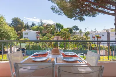 a table with two chairs and a table with a view at LE BELLA studio avec balcon idéal pour une évasion à deux, au calme et proche du centre-ville in Cannes