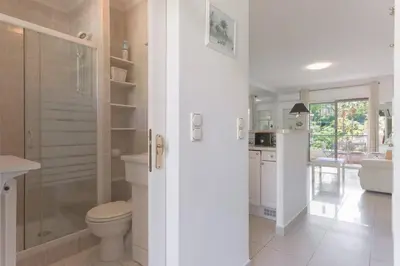 a bathroom with a toilet and a glass shower at LE BELLA studio avec balcon idéal pour une évasion à deux, au calme et proche du centre-ville in Cannes